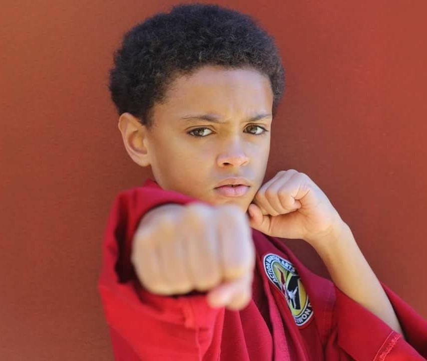 Confident individual practicing bully defense strategies, promoting empowerment and resilience through self-defense training to address and counteract bullying situations